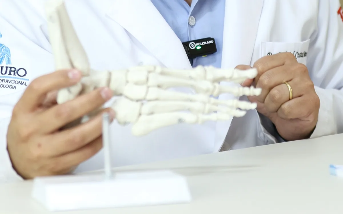 Dr. Gabriel Costa Martins segurando um modelo anatômico do pé